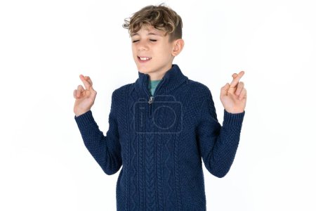 Photo for Handsome caucasian teenager boy on white studio background gesturing finger crossed smiling with hope and eyes closed. Luck and superstitious concept. - Royalty Free Image