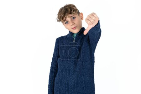 Photo for Handsome caucasian teenager boy on white studio background feeling angry, annoyed, disappointed or displeased, showing thumbs down with a serious look - Royalty Free Image