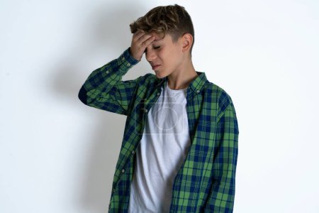 Photo for A very upset and lonely handsome caucasian teenager boy on white studio background crying - Royalty Free Image