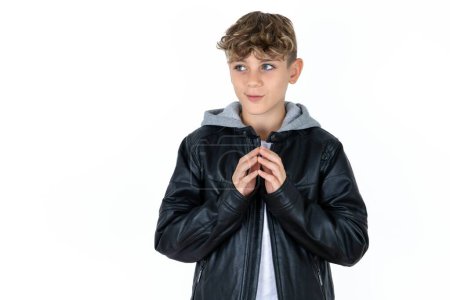 Photo for Handsome caucasian teenager boy on white studio background steepled fingers and looks mysterious aside has great evil plan in mind - Royalty Free Image