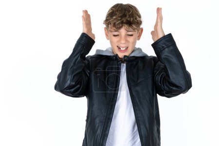 Photo for Handsome caucasian teenager boy on white studio background goes crazy as head goes around feels stressed because of horrible situation - Royalty Free Image