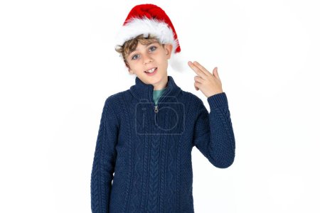 Photo for Handsome caucasian teenager boy on white studio background foolishness around shoots in temple with fingers makes suicide gesture. Funny model makes finger gun pistol - Royalty Free Image