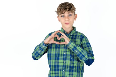 Photo for Serious handsome caucasian teenager boy on white studio background keeps hands crossed stands in thoughtful pose concentrated somewhere - Royalty Free Image