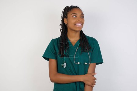 Photo for Positive human facial expressions and emotions. Isolated shot of attractive doctor girl looking and smiling broadly at camera during nice conversation with someone. - Royalty Free Image