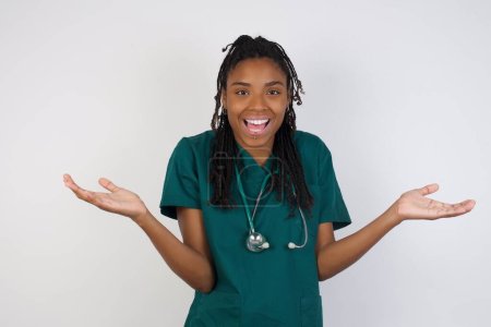 Photo for So what? Portrait of arrogant unbothered good-looking modern young african american doctor woman shrugging careless hands sideways smiling gasping indifferent, telling something obvious. - Royalty Free Image