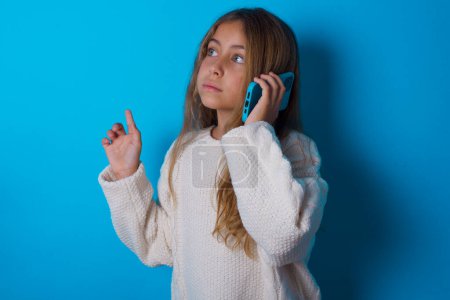 pretty teen girl speaks on mobile phone spends free time indoors calls to friend.