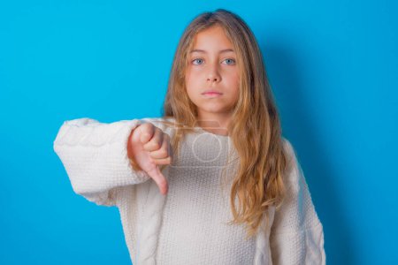Photo for Pretty teen girl looking unhappy and angry showing rejection and negative with thumbs down gesture. Bad expression. - Royalty Free Image