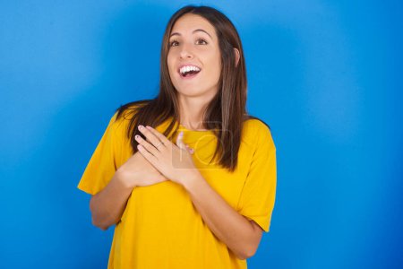 Photo for Portrait of young surprised young woman on blue background - Royalty Free Image