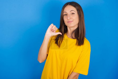 Photo for Closeup of cheerful beautiful young woman looks joyful, satisfied and confident, points at himself with thumb. - Royalty Free Image