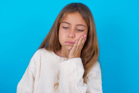 Photo for Pretty teen girl with toothache on blue - Royalty Free Image