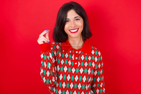 Photo for Brunette caucasian woman wearing christmas sweater over red background pointing up with hand showing up seven fingers gesture in Chinese sign language Q. - Royalty Free Image