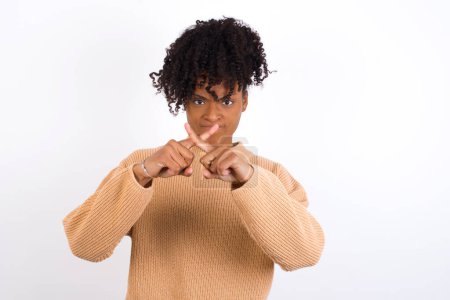 Photo for Young woman has rejection angry expression crossing fingers doing negative sign. - Royalty Free Image