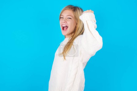 Photo for Overjoyed pretty girl glad to receive good news, clenching fist and making winning gesture. - Royalty Free Image