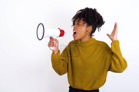 Photo for Young woman communicates shouting loud holding a megaphone, expressing success and positive concept, idea for marketing or sales. - Royalty Free Image