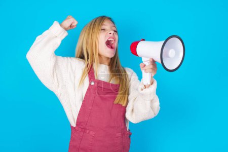 Photo for Pretty teen girl communicates shouting loud holding a megaphone, expressing success and positive concept, idea for marketing or sales. - Royalty Free Image