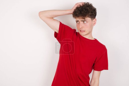 Photo for Handsome young man over white background saying: Oops, what did I do? Holding hand on head with frightened and regret expression. - Royalty Free Image