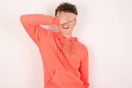 Photo for Happy handsome young man over white background closing eyes with hand going to see surprise prepared by friend standing and smiling in anticipation for something wonderful. - Royalty Free Image