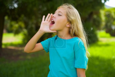 teen pretty girl screaming at side in park