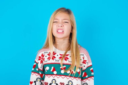 Photo for Mad crazy pretty teen girl clenches teeth angrily, being annoyed with coming noise. Negative feeling concept. - Royalty Free Image