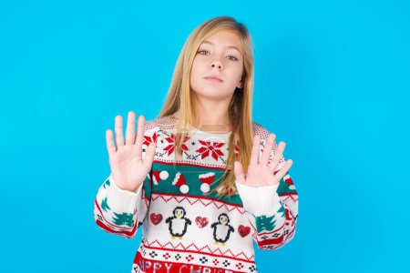 Photo for Pretty girl doing stop sing with palm of the hand. Warning expression with negative and serious gesture on the face. - Royalty Free Image