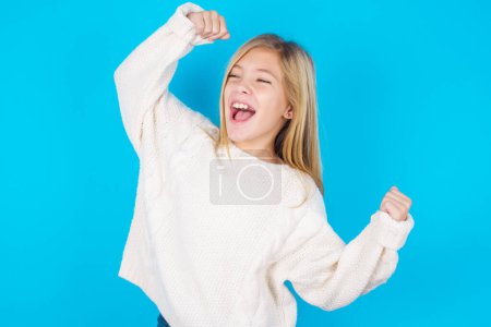 Photo for Yes I am winner. Portrait of charming delighted and excited pretty girl raising up fist in triumph and victory smiling achieving success grinning from delight. - Royalty Free Image