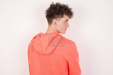 Photo for The back view of handsome young man over white background. Studio Shoot. - Royalty Free Image