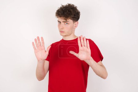 Photo for Young man doing stop sing with palm of the hand. Warning expression with negative and serious gesture on the face. - Royalty Free Image