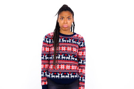 Photo for African American woman wearing Christmas sweater against white wall crying desperate and depressed with tears on his eyes suffering pain and depression. Sad facial expression and emotion concept. - Royalty Free Image