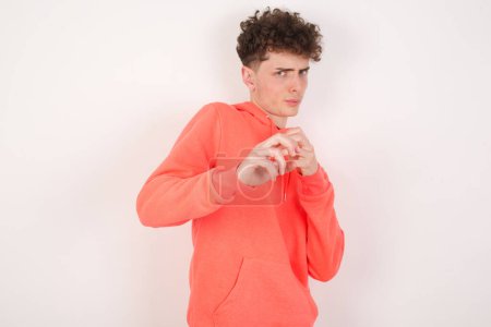 Photo for Ugh how disgusting! Displeased handsome young man over white background has dissatisfied facial expression as sees something abominable. - Royalty Free Image