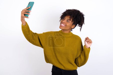 Photo for Portrait of a young woman  taking a selfie to send it to friends and followers or post it on his social media. - Royalty Free Image