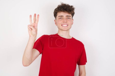 Photo for Handsome young man over white background showing and pointing up with fingers number three while smiling confident and happy. - Royalty Free Image
