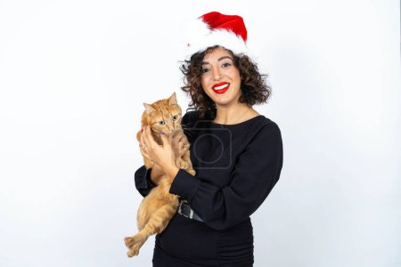 Photo for Young beautiful woman with curly hair wearing black dress and holding and hugging an orange cat - Royalty Free Image