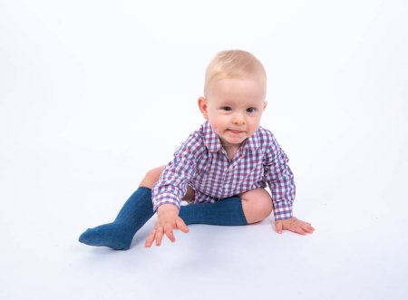 Photo for Portrait of cute little kid boy wearing plaid shirt while having fun over white studio background - Royalty Free Image