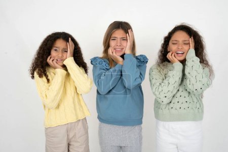 Photo for Doleful desperate crying three teenager girls looks stressfully, frowns face, feels lonely and anxious - Royalty Free Image