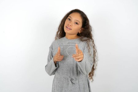 Photo for Teenager girl wearing grey sweater pointing fingers to camera with happy and funny face. Good energy and vibes. - Royalty Free Image