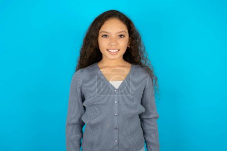Photo for Teenager girl wearing grey sweater keeps teeth clenched, frowns face in dissatisfaction, irritated because of much duties. - Royalty Free Image