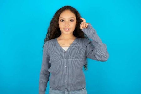 Photo for Teenager girl wearing grey sweater pointing up with fingers number nine in Chinese sign language Jiu - Royalty Free Image