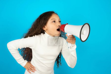 Photo for Funny teenager girl wearing white sweater People sincere emotions lifestyle concept. Mock up copy space. Screaming in megaphone. - Royalty Free Image