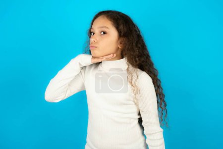 Photo for Teenager girl wearing white sweater cutting throat with hand as knife, threaten aggression with furious violence. - Royalty Free Image