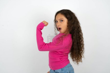 Photo for Profile side view portrait teenager girl wearing pink sweater celebrates victory - Royalty Free Image
