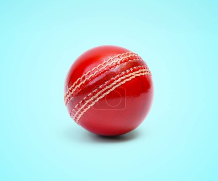 A Shiny New Test Cricket Match Ball Leather Hard Stitched Ball Closeup Photo On Blue Background