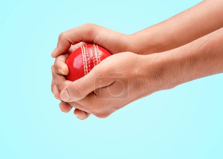 A Man Hands Taking The Catch Of A Red Leather Test Cricket Ball Closeup Photo On Blue Background