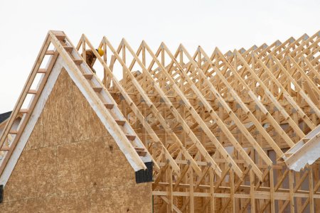 Foto de Installation of rafters of a plywood house building wall studs wooden roof framework truss wood - Imagen libre de derechos