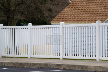 Photo for White vinyl fence in residential neighborhood home nature plastic - Royalty Free Image