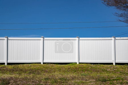 Photo for Vinyl fence white grass security property plastic - Royalty Free Image