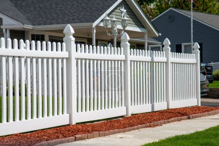 Photo for White vinyl fence in residential neighborhood home nature plastic property backyard - Royalty Free Image