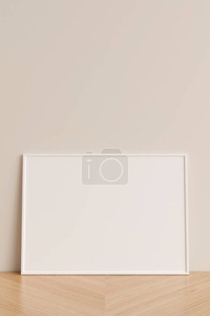 Foto de Vista frontal limpia y minimalista horizontal blanco foto o cartel marco maqueta apoyada contra la pared en el suelo de madera. renderizado 3d. - Imagen libre de derechos
