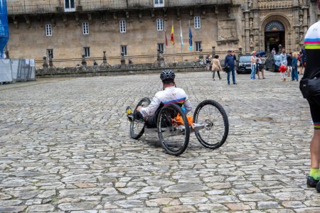 Photo for Santiago de Compostela, La Coruna, Galicia, Spain  - 13 June, 2023. Pilgrim with disability arriving at Santiago de Compostela. - Royalty Free Image