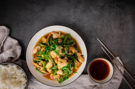 Tasty Stir-fried pork and red hot curry paste with long bean Ingredients are oyster sauce, fish sauce, sugar, and kaffir lime leaves in the dish Eat with cooked rice. Thai cuisine top view