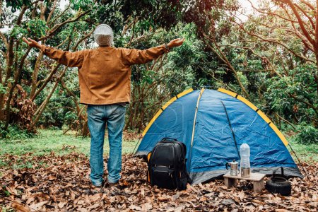 Photo for Backpacker Asian man standing open arms is freedom and relax on the weekends. holiday camping alone on vacation. - Royalty Free Image